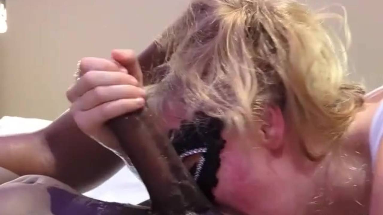 Blonde slut with a mask fucks a black cock