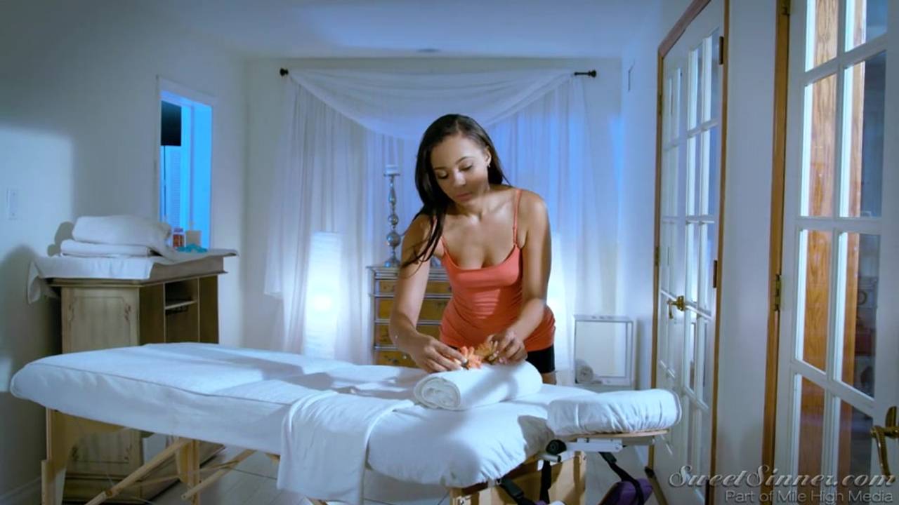 A brunette enjoying herself in a massage room