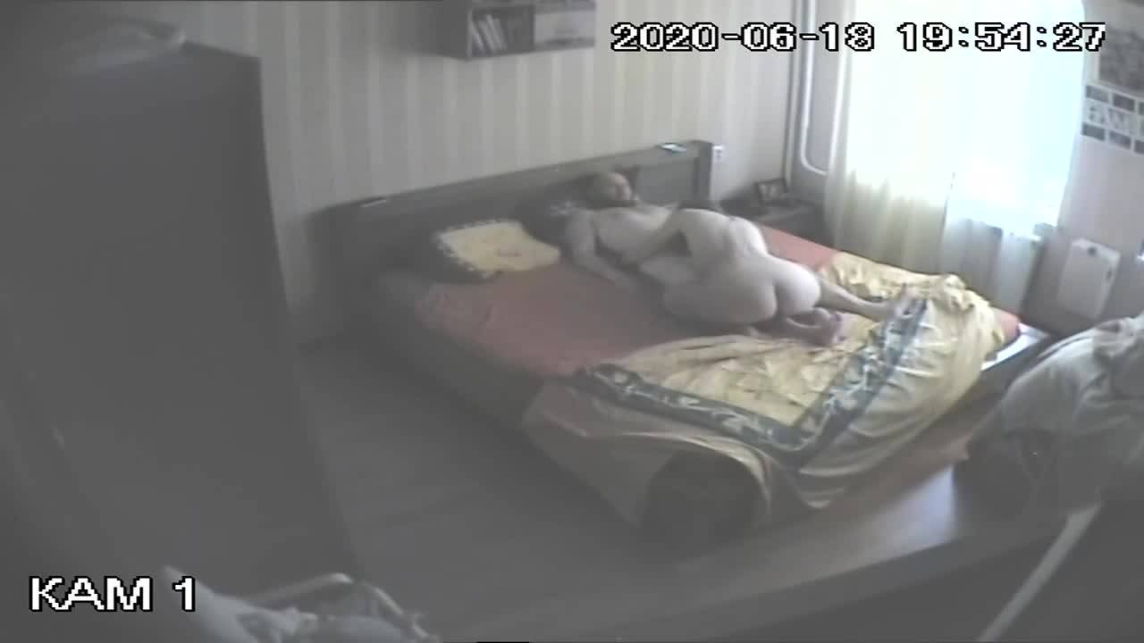 The voyeur films them fucking on the bed