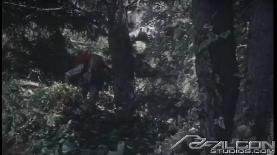 Guy plays with his cock underneath a tree